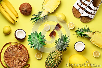 Stylish rattan bag, coconut, birkenstocks, succulent, sunglasses and yellow fruits on sunny background. Banner. Top view Stock Photo