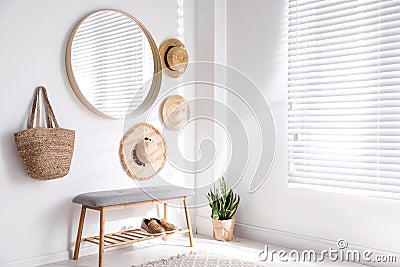 Stylish round mirror hanging on white wall in room Stock Photo