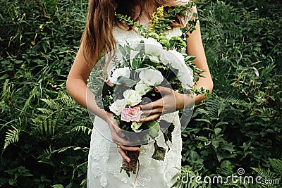 Stylish rustic bouquet in the hand of gorgeous boho bride on the Stock Photo