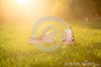 Stylish sandals, lie on the grass Stock Photo