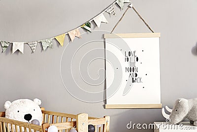 Stylish scandinavian nursery interior with hanging mock up poster, natural toys, teddy bears, children`s accessories and design Stock Photo