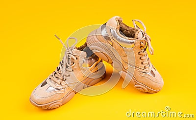 stylish sporty sneakers on yellow background, footgear Stock Photo