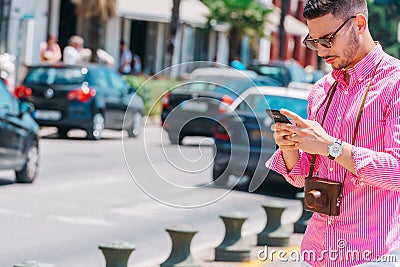 Stylish tourist calling a lift on his smartphone Stock Photo