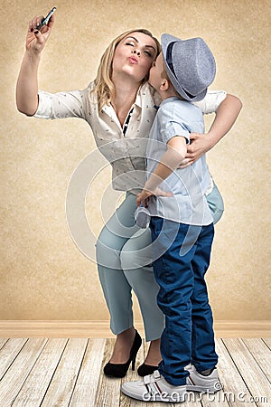 Mother and son take a selfie photo on their mobile phone.Stylish,trendy,modern Stock Photo