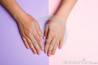 Stylish trendy women manicure. Hand and nail care. Female hands with perfect pastel pink nails on colorful background. Manicured w Stock Photo