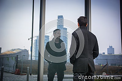 Stylish trendy young man standing outdoor in front Stock Photo