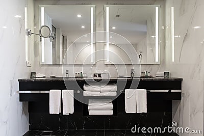 Stylish twin bathroom with two sinks and mirror. Stock Photo