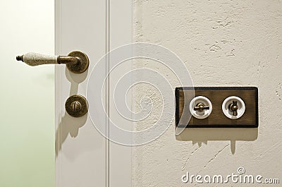 Stylish vintage brass light switchers and door knob Stock Photo