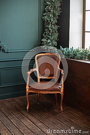 Stylish vintage brown armchair. Cozy retro living room decorated Christmas or new year. Stock Photo