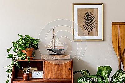 Stylish, vintage, wooden commode, plants and mock up poster frame. Stock Photo