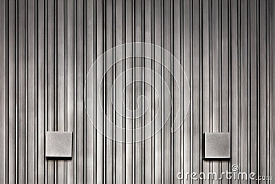 Stylish wall lights and wood wall with black silver vertical rails Stock Photo