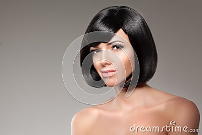 Stylish woman with a bob hairstyle. Girl model with a short black fringe and vlosami. Stock Photo