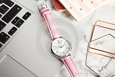 Stylish wrist watch and laptop on office table Stock Photo