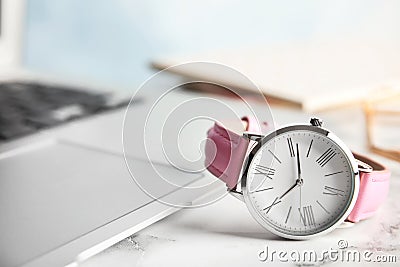Stylish wrist watch on office table, space for text. Stock Photo