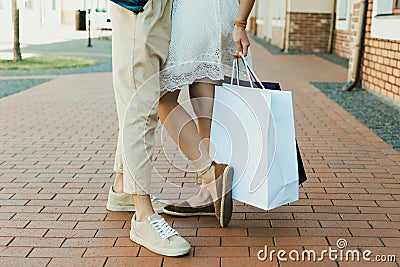 Stylish young couple holding shopping bags while standing together Stock Photo