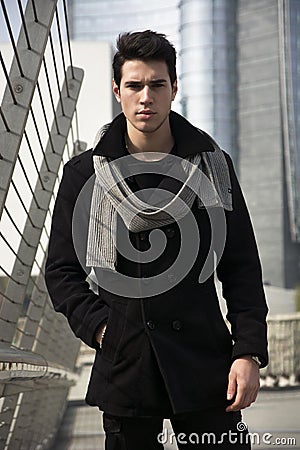 Stylish Young Handsome Man in Black Coat Standing Stock Photo