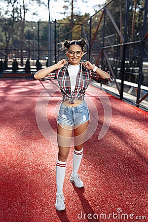 Stylish young teenage hipster girls posing with happy face at the stadium. Stock Photo