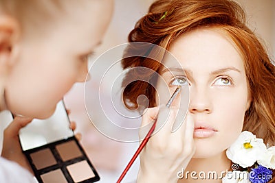 Stylist makes makeup bride on the wedding day Stock Photo