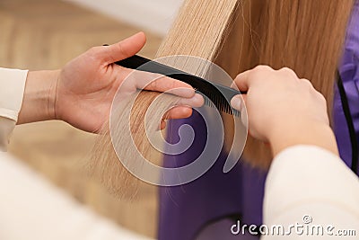 Stylist working with client in salon, closeup. Making haircut Stock Photo