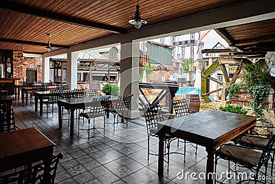 Stylization of a medieval tavern. Interior of an outdoor restaurant in a luxury boutique hotel Editorial Stock Photo