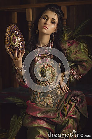 Stylized vintage portrait of young woman in ethno style Stock Photo