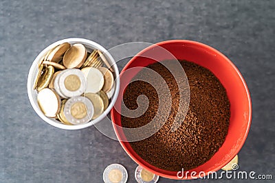 Styrofoam cup full of coins with red bowl of instant coffee Stock Photo