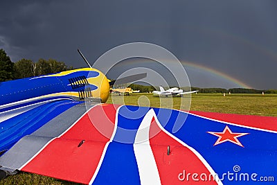 SU-26 sport airplane on the airfield. Rainbow over the sky. Editorial Stock Photo