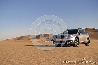 Subaru Outback standing in the middle of the Namib desert. Stock Photo