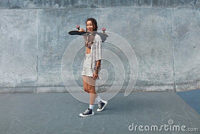 Subculture. Skater Girl With Skateboard At Skatepark Full-Length Portrait. Stock Photo