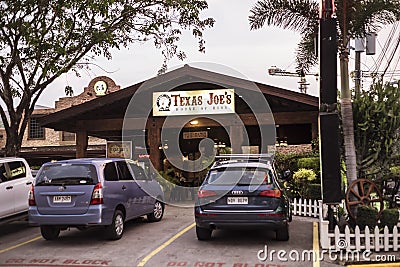 Subic, Philippines - Texas Joe's restaurant along waterfront road. Nightlife and dining district in Subic Bay Freepor Editorial Stock Photo