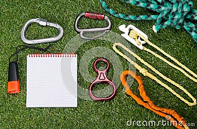 The subject of the insurance climber and a tourist kit are on the green background of the lawn. and there is a place to write on Stock Photo