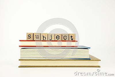 Subject word on wood stamps and books Stock Photo