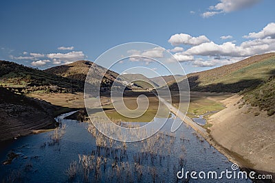 Submerged old road in a valley visible due to a low water level of the RiaÃ±o reservoir Stock Photo