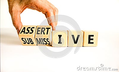 Submissive or assertive symbol. Concept words Submissive and assertive on wooden cubes. Businessman hand. Beautiful white Stock Photo