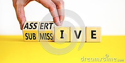 Submissive or assertive symbol. Concept words Submissive and assertive on wooden cubes. Businessman hand. Beautiful white Stock Photo