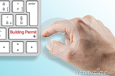 SUBMITTING FOR A BUILDING PERMIT CONCEPT with fictional Building Permit and text written over computer keyboard Stock Photo