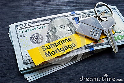 Subprime mortgage. Stack of cash and key. Stock Photo
