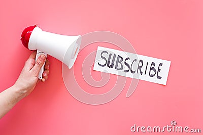 Subscribe template or mockup. Hand lettering subcribe near megaphone on pink background top view space for text Stock Photo