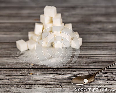 Substitution of sugar. Small pill of sweetener and big heap of s Stock Photo