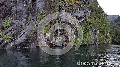 The subtlety of the small waterfall, fjord cruise Bergen-Mostraumen, Norway â€“ July 2017 Stock Photo