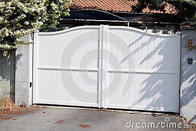 Suburb portal home white high house gate slats gate Stock Photo