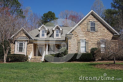Suburban house with stone exterior in an affluent neighborhood Stock Photo