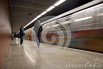 Subway train leaving the station and people waiting for the next one Editorial Stock Photo