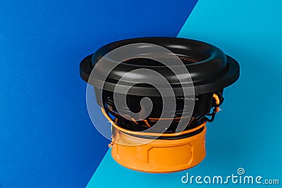 The subwoofer is black on a blue-blue background. Auto sound Stock Photo