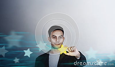 Success in Business or Personal Talent Concept. Happy Businessman Employee Smiling and Showing a Golden Star Stock Photo