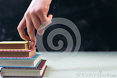 Success concept with fingers climbing stairs made of books stack Stock Photo