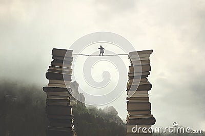 Success and knowledge concepts of a man walking on a rope to move from one pile of books to another Stock Photo