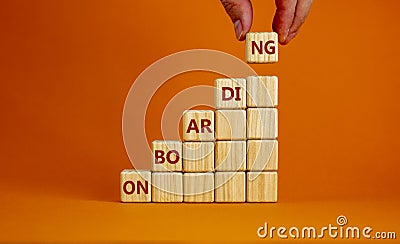 Wooden cubes stacking as step stair on orange background copy space. Businessman hand. Word ' Stock Photo