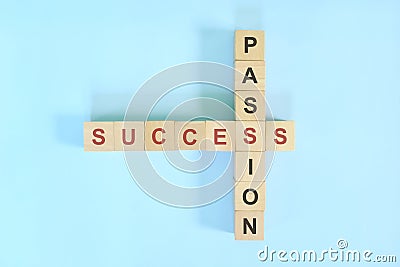 Success and passion business and career concept. Wooden block crossword puzzle flat lay in blue background. Stock Photo