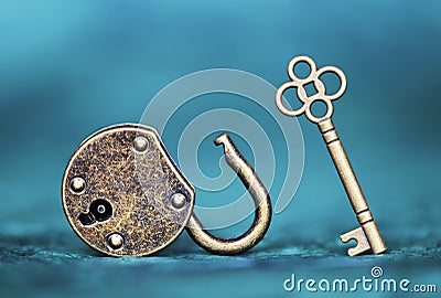 Success, solution, coaching concept, key and padlock on blue background Stock Photo